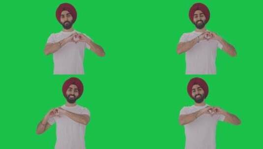 快乐的锡克教印度人显示心形标志绿屏高清在线视频素材下载