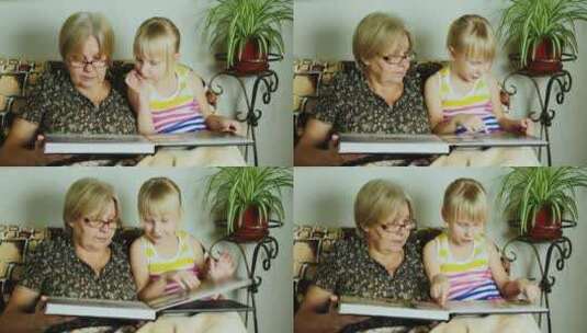 孙女和祖母翻看相册高清在线视频素材下载