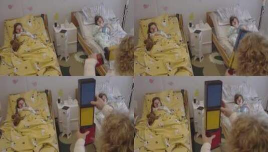 生病的孩子躺在病床上看小丑表演高清在线视频素材下载