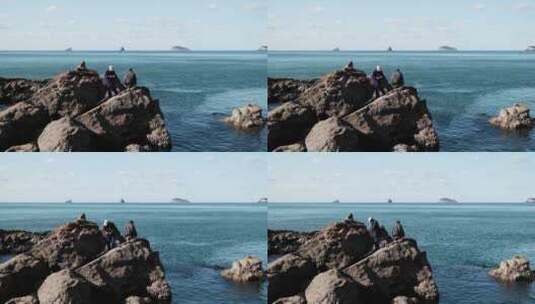 4k拍摄在礁石上海钓的大叔高清在线视频素材下载