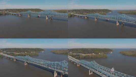 无人机拍摄到伊利诺伊州皮奥里亚的麦克克鲁吉奇桥。一艘划艇缓慢地经过这座桥高清在线视频素材下载