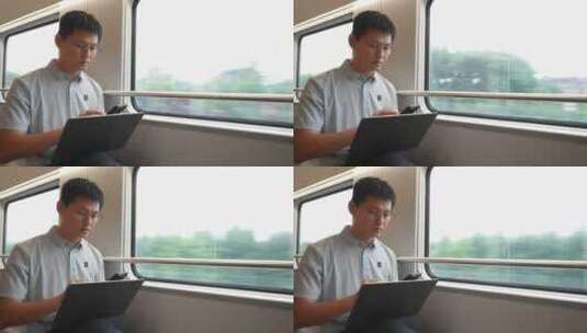 中年男子在火车上使用笔记本电脑工作高清在线视频素材下载
