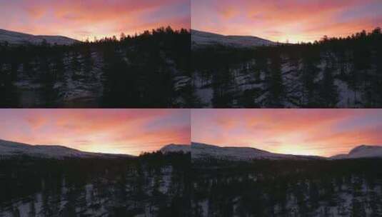 挪威白雪皑皑的森林上充满活力的日落色相，高清在线视频素材下载
