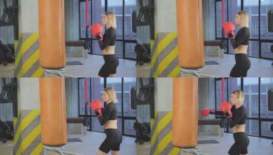 女人在健身房打沙袋练习拳击高清在线视频素材下载