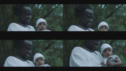 黑人父亲在森林给女儿洗礼高清在线视频素材下载