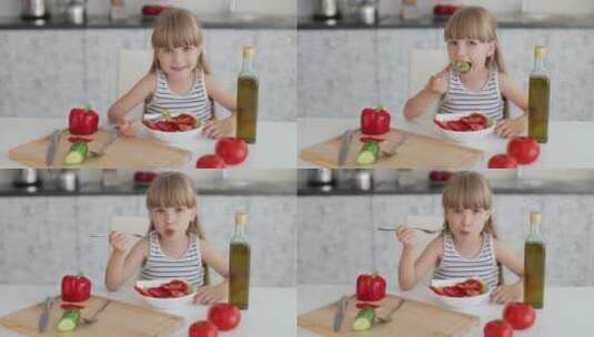 小女孩坐在餐桌前吃蔬菜沙拉高清在线视频素材下载