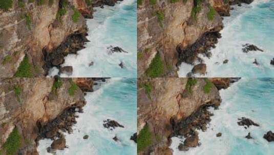 青绿色的海浪撞击悬崖的鸟瞰高清在线视频素材下载
