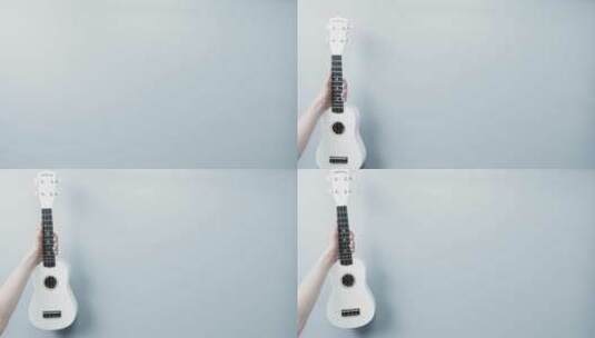 白色背景下的尤克里里吉他高清在线视频素材下载
