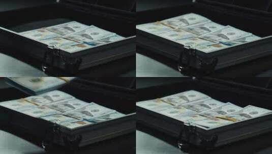 数美国百元钞票，把钱放在金属手提箱里高清在线视频素材下载
