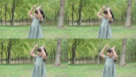 在公园草坪上玩耍的中国女孩高清在线视频素材下载