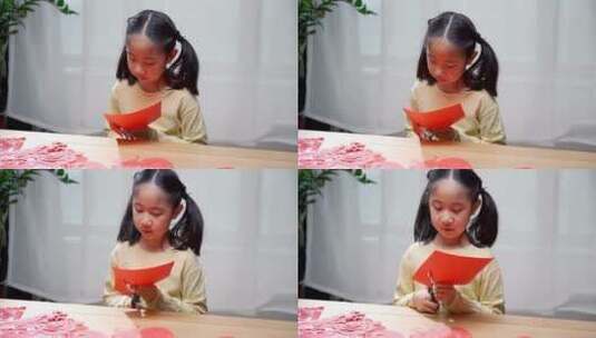 认真玩剪纸游戏的中国女孩高清在线视频素材下载