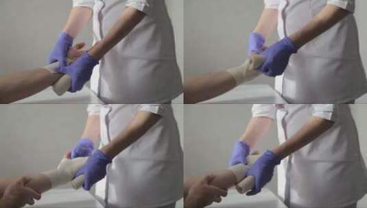 医生在病人的手腕上贴了一条弹性绷带高清在线视频素材下载