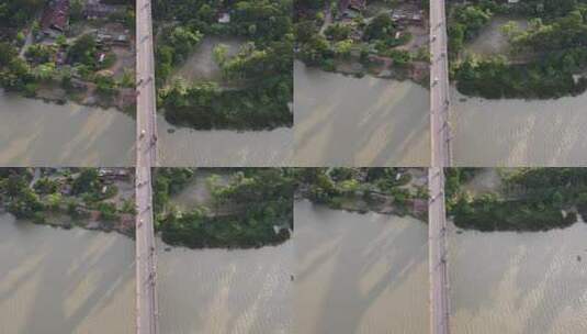 俯视图跟随车辆在孟加拉国泥泞河上的桥路行驶高清在线视频素材下载