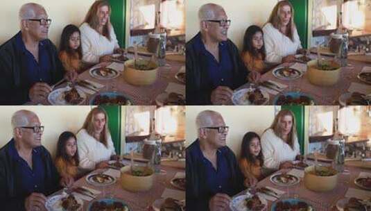 快乐的拉丁女孩在家和祖父母一起吃饭很开心高清在线视频素材下载