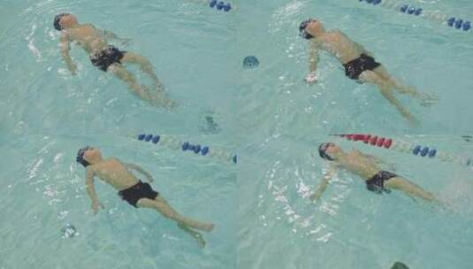 游泳池培训班小男孩学习游泳漂浮水面高清在线视频素材下载
