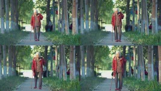 老人老年女性拄着拐杖在公园散步高清在线视频素材下载