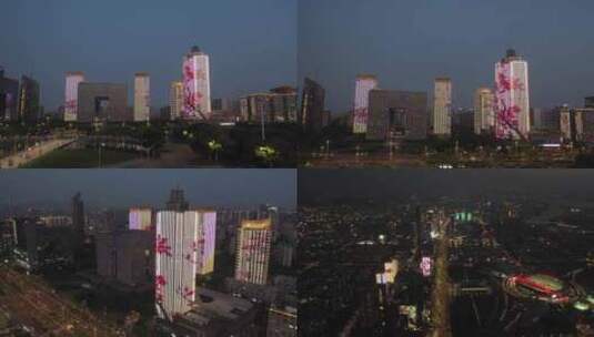 晚上航拍城市高楼梅花图案亮化高清在线视频素材下载