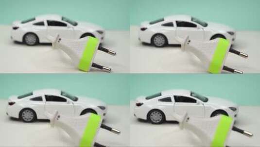 玩具车和电插头。电动汽车和绿色汽车概念高清在线视频素材下载