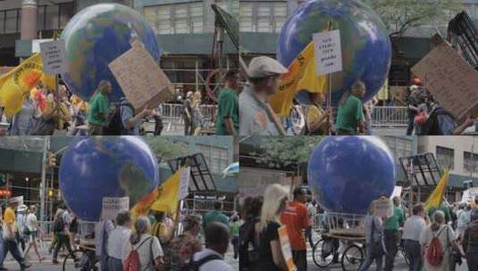 美国纽约市——2014年9月21日——抗议者在人民气候游行中拉着一个旋转的地球，这是一个倡导全球应对气候变化行动的大型活动。高清在线视频素材下载