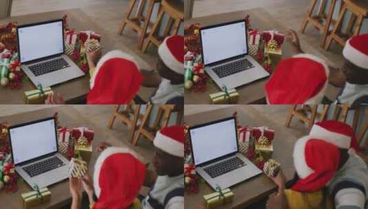 戴着圣诞帽的不同夫妇进行圣诞笔记本电脑视频通话的视频，屏幕上有复制空间高清在线视频素材下载
