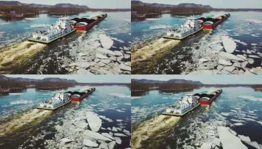 航拍在有冰的河上航行的驳船高清在线视频素材下载