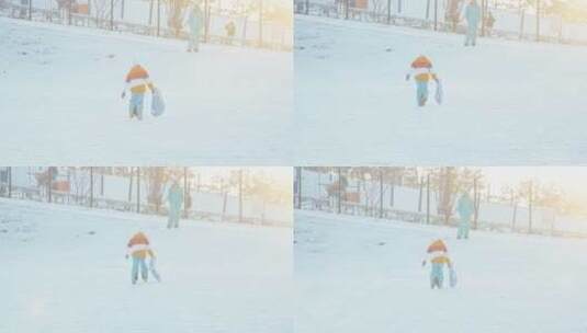 女孩和妈妈在雪地里玩耍高清在线视频素材下载