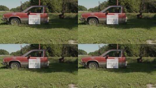 草坪上的一半汽车上贴着离婚分到二分之一汽车的标牌高清在线视频素材下载