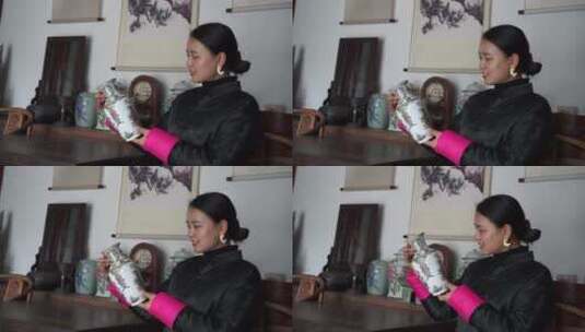 中式胡同四合院女人欣赏花瓶高清在线视频素材下载