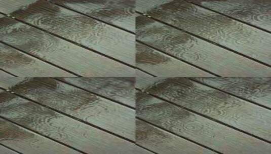 （慢镜）下雨天雨水落在防腐木地板上高清在线视频素材下载