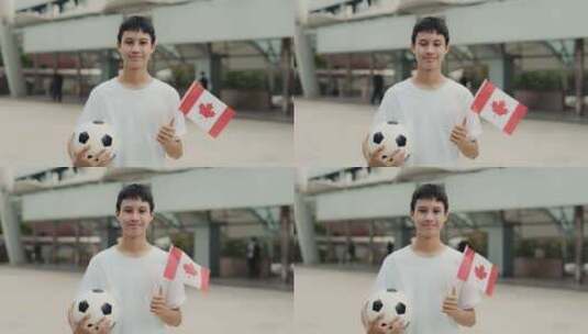 亚洲青少年足球迷在户外与加拿大国旗和球合高清在线视频素材下载