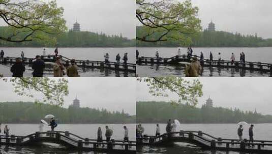 雨天的杭州西湖边散步的游客人群高清在线视频素材下载