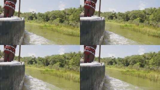 慢镜头原住民驾船驶过河流高清在线视频素材下载