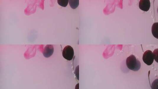 樱桃落入粉色背景的水中高清在线视频素材下载