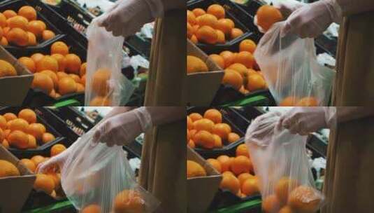 女人在杂货店挑选橙子手套中的维生素C高清在线视频素材下载