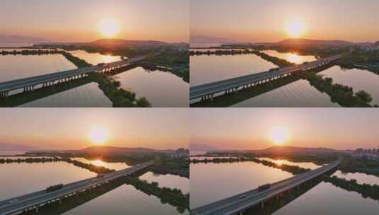 航拍夕阳下穿过鄱阳湖的乡间高速公路高清在线视频素材下载