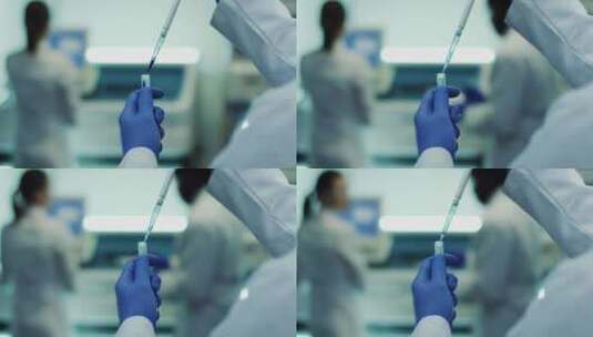 科学家在无菌室穿着防护服实验中使用移液管高清在线视频素材下载