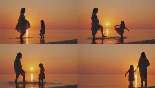 日落时分母女在海滩玩耍高清在线视频素材下载