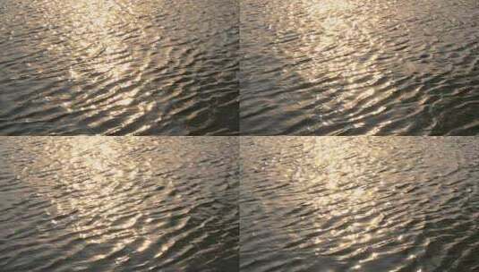 傍晚金色阳光洒在水面上波光粼粼的慢镜头高清在线视频素材下载