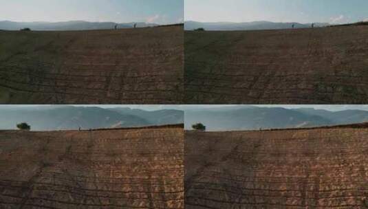 夕阳余晖农民耕地土地喷打农药远景高清在线视频素材下载