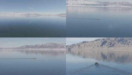 新疆冬日无人机航拍小船在赛里木湖行驶高清在线视频素材下载
