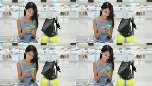 在机场玩手机的女人高清在线视频素材下载