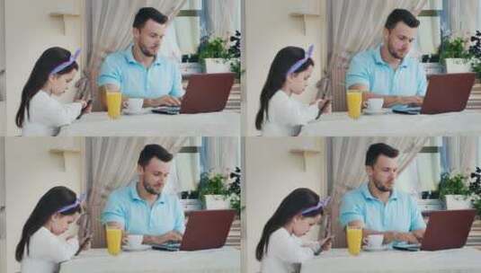 男人用笔记本电脑女儿用智能手机高清在线视频素材下载