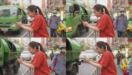 妇女在曼谷街头使用智能手机高清在线视频素材下载