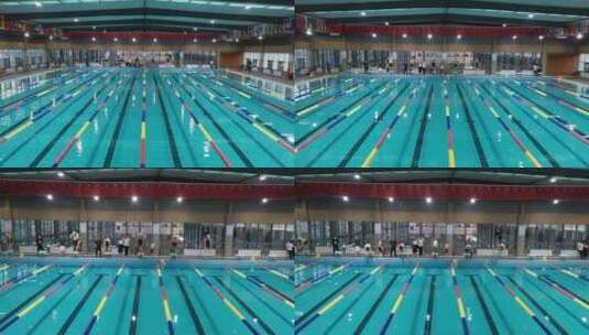 游泳馆里的比赛航拍跳入水中高清在线视频素材下载