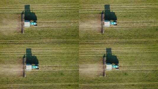 农业拖拉机在小麦农作物中耕作土壤高清在线视频素材下载