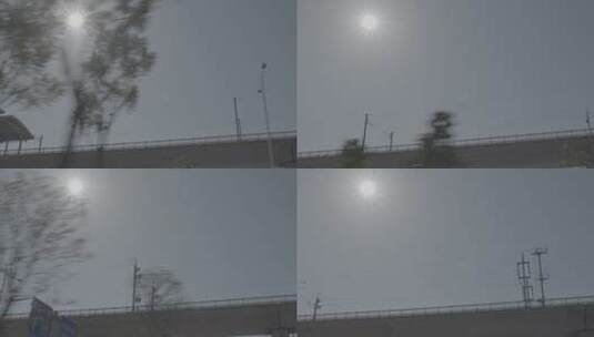 阳光下汽车行驶仰拍高铁动车高架轨道慢镜头高清在线视频素材下载