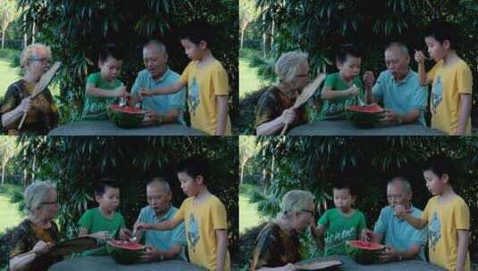炎热夏天爷爷奶奶和孙子一起吃西瓜高清在线视频素材下载