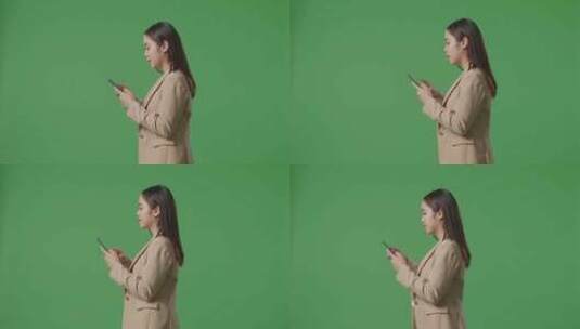 亚洲女商人使用手机和走在绿屏色度键的侧视图高清在线视频素材下载