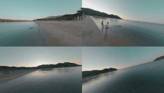 情侣带小狗在海边游泳FPV穿越机无人机航拍高清在线视频素材下载