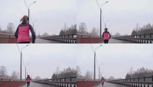 寒冷天气在桥上跑步的女运动员高清在线视频素材下载